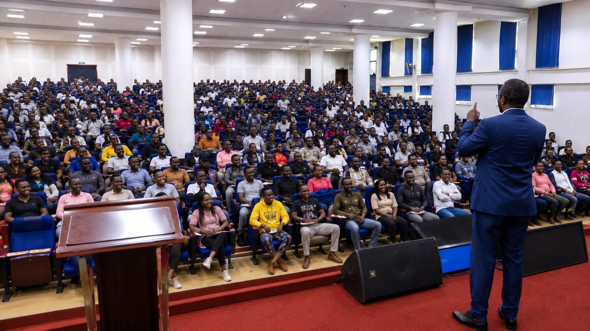 Dr. Job Mogire speaking to a full House of Mastery audience in an auditorium